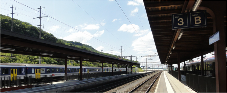 Austrian train station platform with a local commuter train