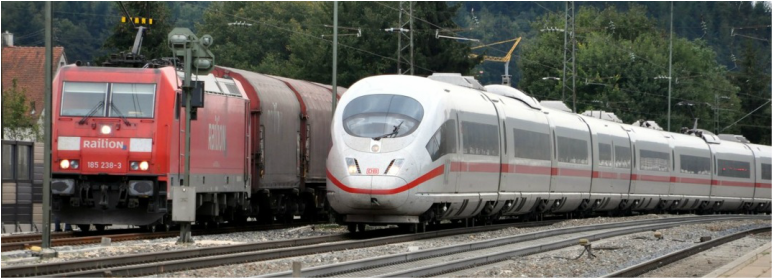 German ICE train passing a freight train headed by a class 185 electric locomotive